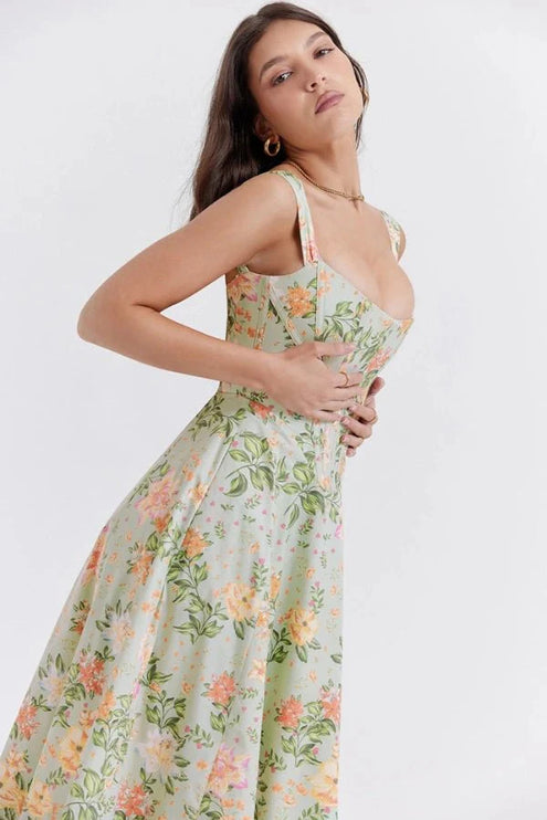 Side view of green floral off shoulder midi dress with corset bodice and flowing skirt