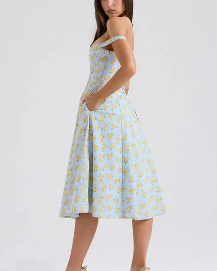 Side back view of floral midi dress showing off shoulder sleeves, fitted waist, and flowing skirt