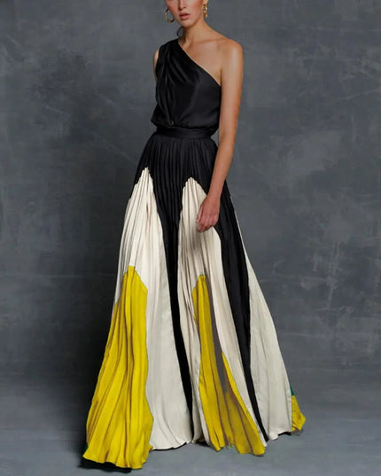 One-shoulder black maxi dress with pleated yellow and cream color block skirt