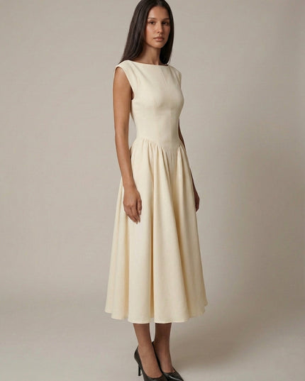 Side view of cream sleeveless midi dress with cinched waist and flared skirt, formal dress
