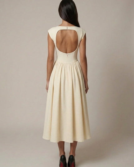 Back view of cream sleeveless midi dress with open back detail and gathered skirt