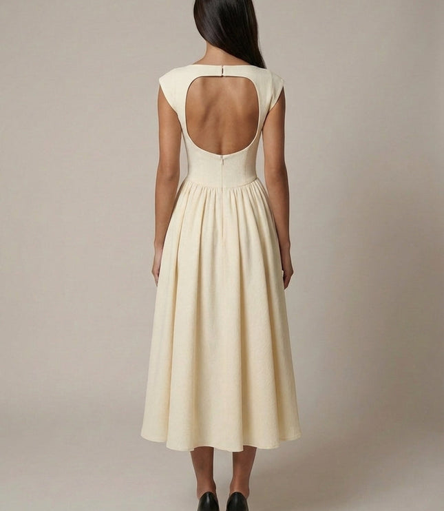Back view of cream sleeveless midi dress with open back detail and gathered skirt
