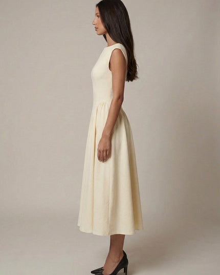 Rear view of cream formal midi dress showing open back cutout and flowing skirt