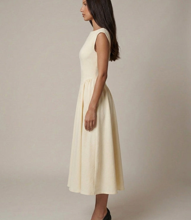 Rear view of cream formal midi dress showing open back cutout and flowing skirt