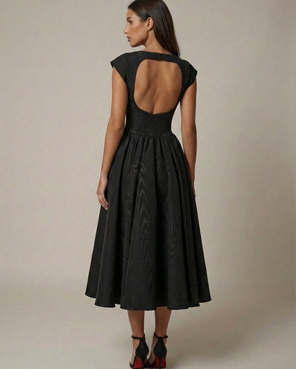 Three-quarter view of black formal midi dress with cap sleeves and flared skirt