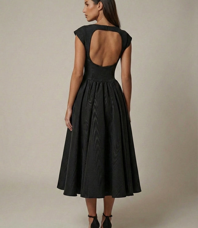 Three-quarter view of black formal midi dress with cap sleeves and flared skirt