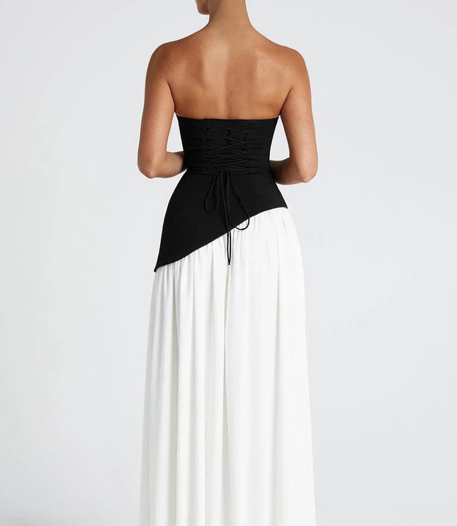Back view of black and white strapless corset maxi dress with draped overlay