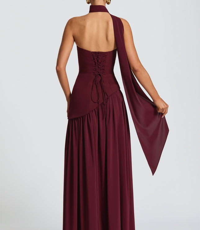 Back view of burgundy strapless corset dress with lace-up closure and halter tie