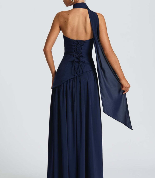Back view of navy formal corset maxi dress with lace-up detail and halter strap