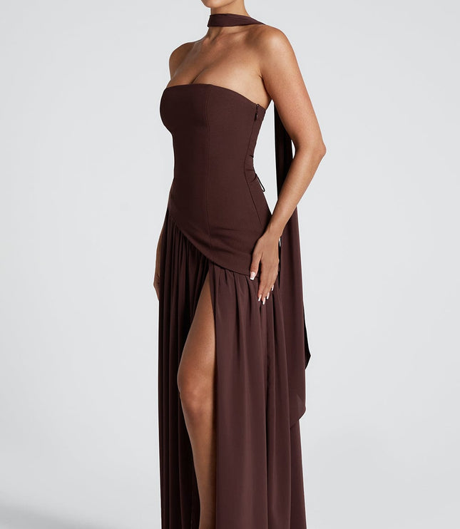 Three-quarter view of brown corset maxi dress with flowing skirt and slit
