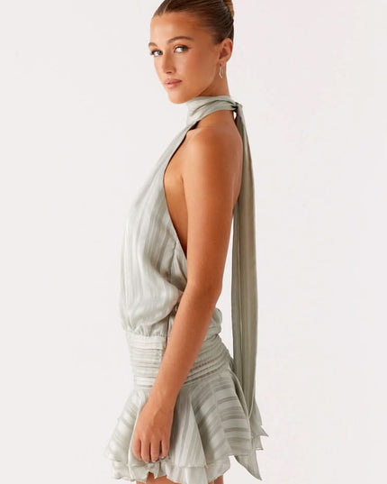Sage green pleated halter mini dress back view showing open backless design