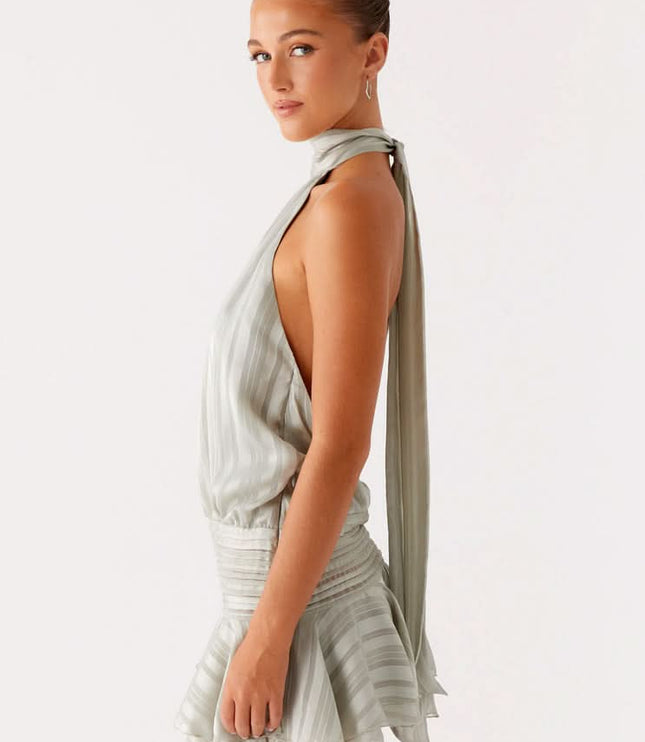 Sage green pleated halter mini dress back view showing open backless design