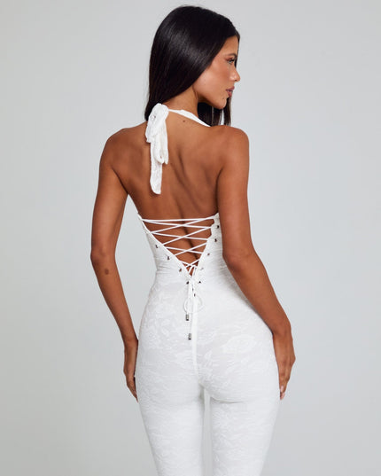 White halter lace jumpsuit with buckled straps and wide-leg silhouette