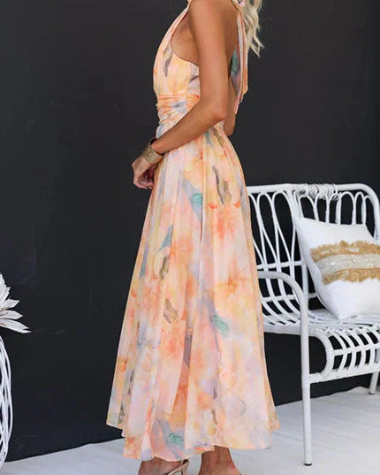 Side view of women's halter floral maxi dress showing open back cutout