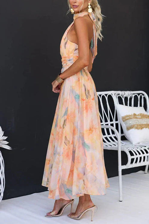 Side view of women's halter floral maxi dress showing open back cutout