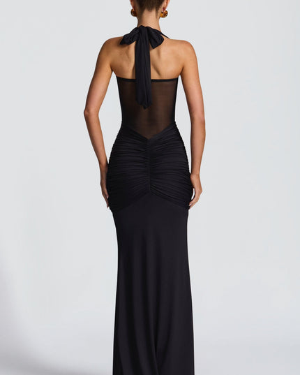 Black halter maxi dress with ruched bodice and sheer mesh back panel
