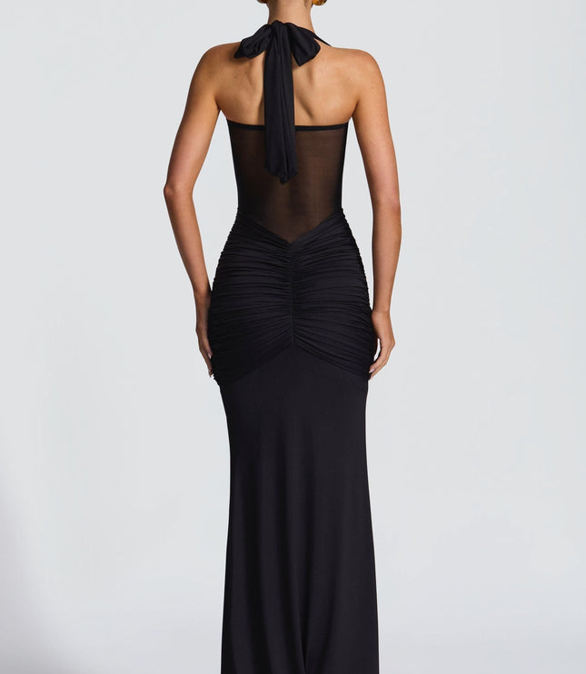 Black halter maxi dress with ruched bodice and sheer mesh back panel
