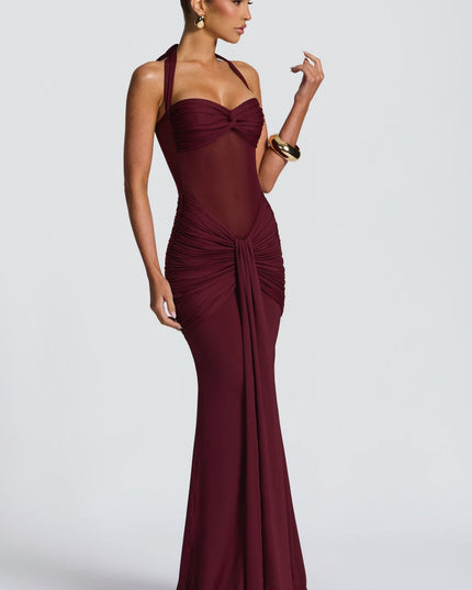 Burgundy halter maxi dress side view with ruched bodice and flowing skirt