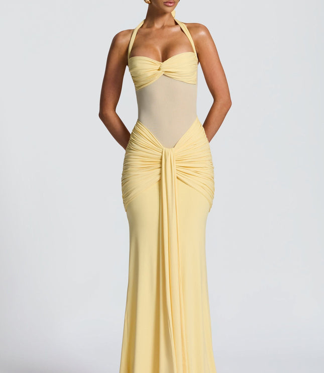 Yellow halter sundress with ruched waist and flowing maxi skirt