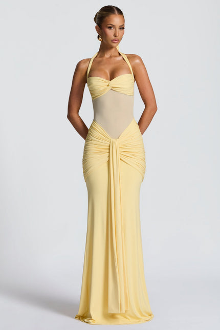 Yellow halter sundress with ruched waist and flowing maxi skirt
