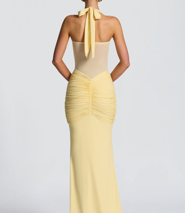 Back view of yellow halter maxi dress with tied neckline