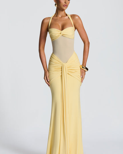 Front view yellow halter sweetheart dress with ruched hip detail and flowing skirt