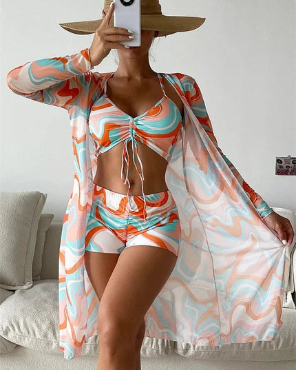 Orange and turquoise abstract print bikini set with high waist shorts and long sleeve cover-up