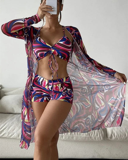 Magenta and navy abstract print bikini set with high waist shorts and long sleeve sheer cover