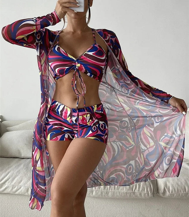 Magenta and navy abstract print bikini set with high waist shorts and long sleeve sheer cover