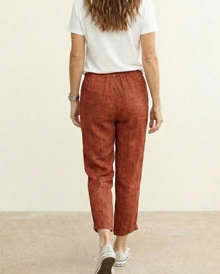 Back view of rust linen casual pants with elastic waistband