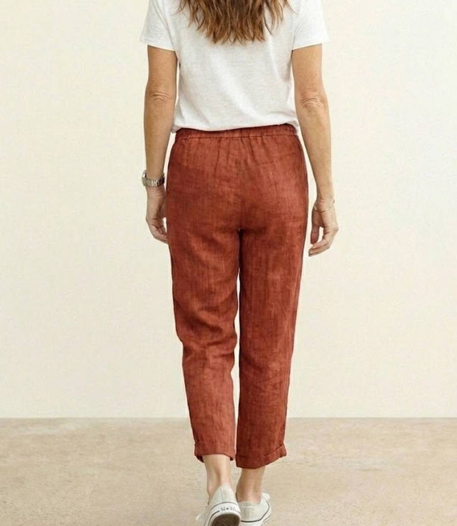 Back view of rust linen casual pants with elastic waistband