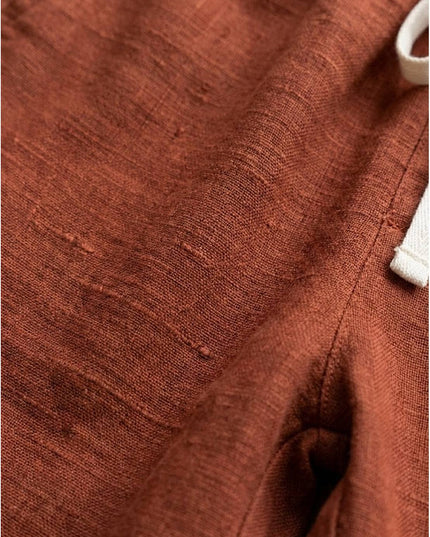 Close-up of rust linen fabric texture and weave detail