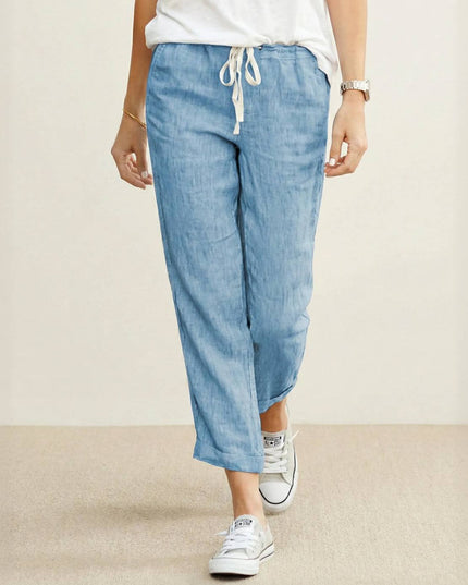Light blue linen drawstring pants with white waistband tie on model