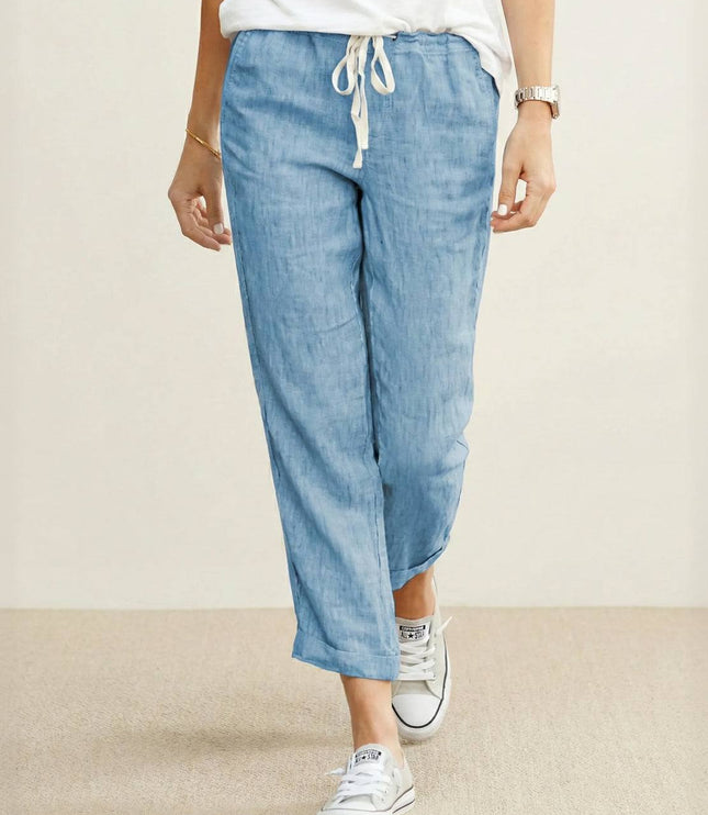 Light blue linen drawstring pants with white waistband tie on model