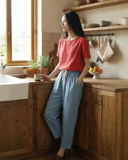 Slate blue linen pants with cream drawstring in kitchen setting