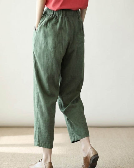 Side view of sage green linen pants showing natural drape and pockets