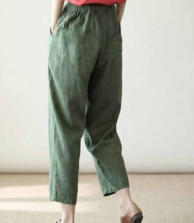 Side view of sage green linen pants showing natural drape and pockets