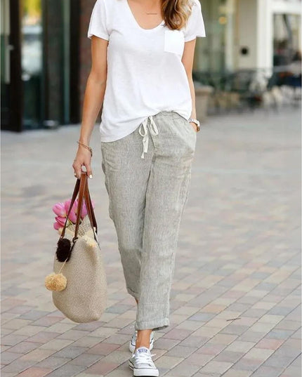 Styled beige linen pants with white tee and accessories