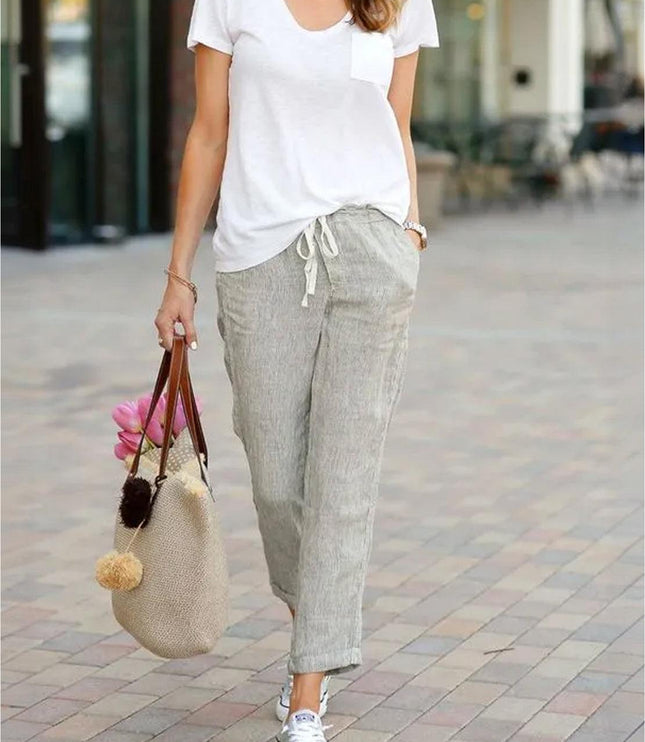 Styled beige linen pants with white tee and accessories