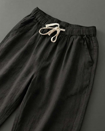 Close-up of cream drawstring on black linen pants waist