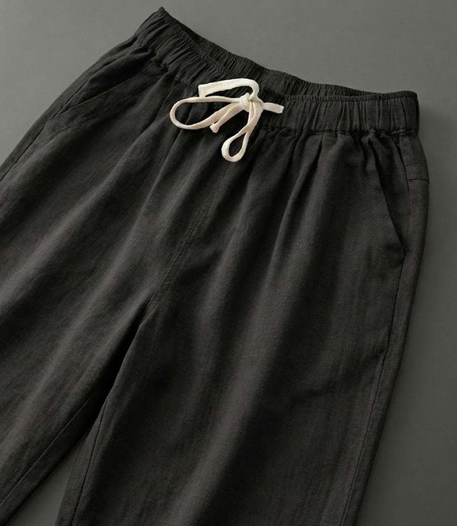 Close-up of cream drawstring on black linen pants waist