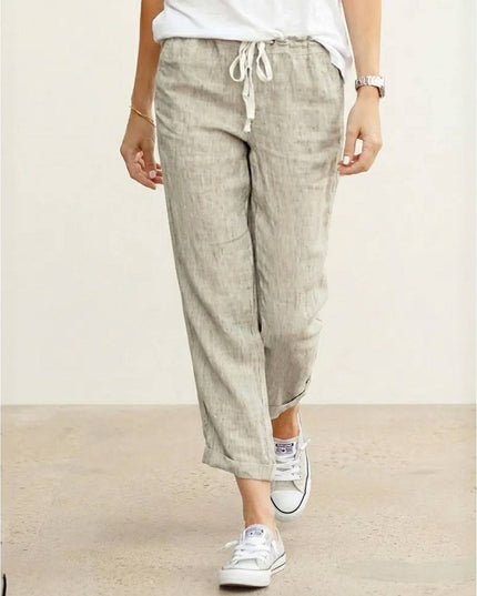 Beige linen pants with drawstring waist and cropped length on model