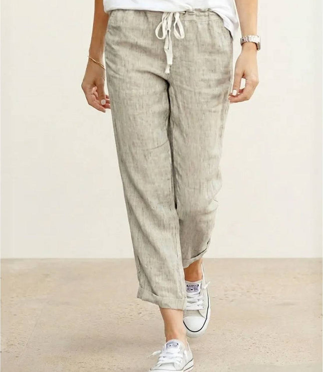 Beige linen pants with drawstring waist and cropped length on model