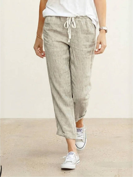 Beige linen pants with drawstring waist and cropped length on model