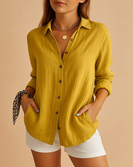 Mustard yellow linen button down shirt styled with rolled sleeves and white shorts