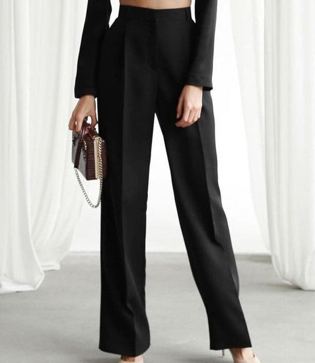 Black high waisted wide leg linen pants paired with a fitted long sleeve top and mini bag