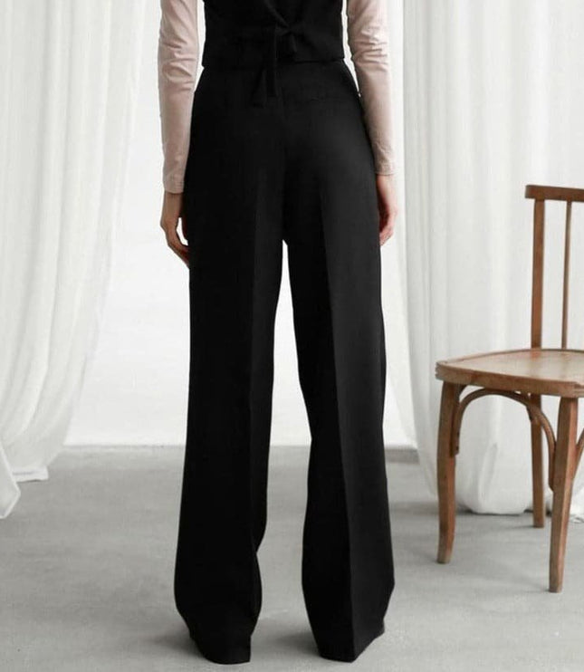 Back view of black high waisted wide leg linen pants with a tailored loose fit
