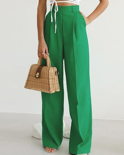Green high waisted wide leg linen pants styled with a white crop top and woven handbag