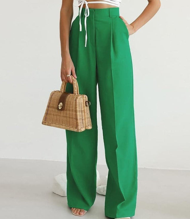Green high waisted wide leg linen pants styled with a white crop top and woven handbag