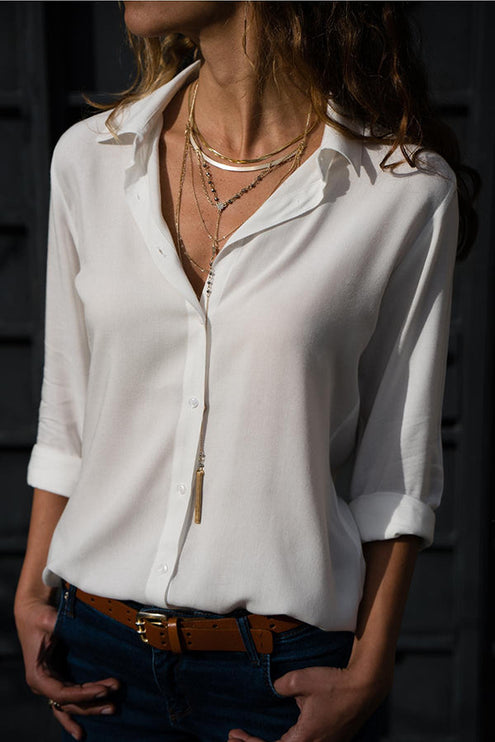 White long sleeve button down collared blouse with rolled cuffs